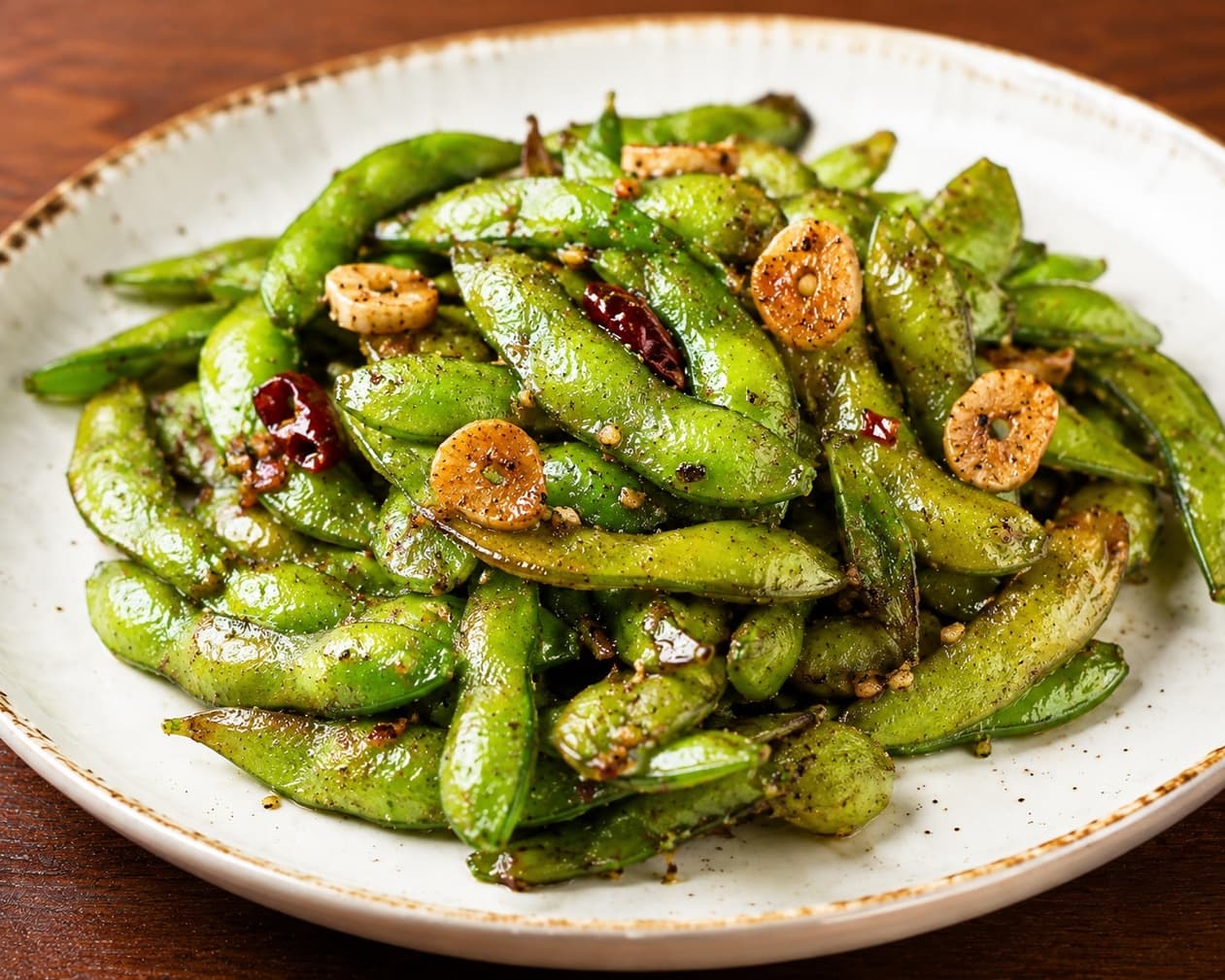 Seasoned edamame with sliced garlic at Sakura Asian Dining & Bar
