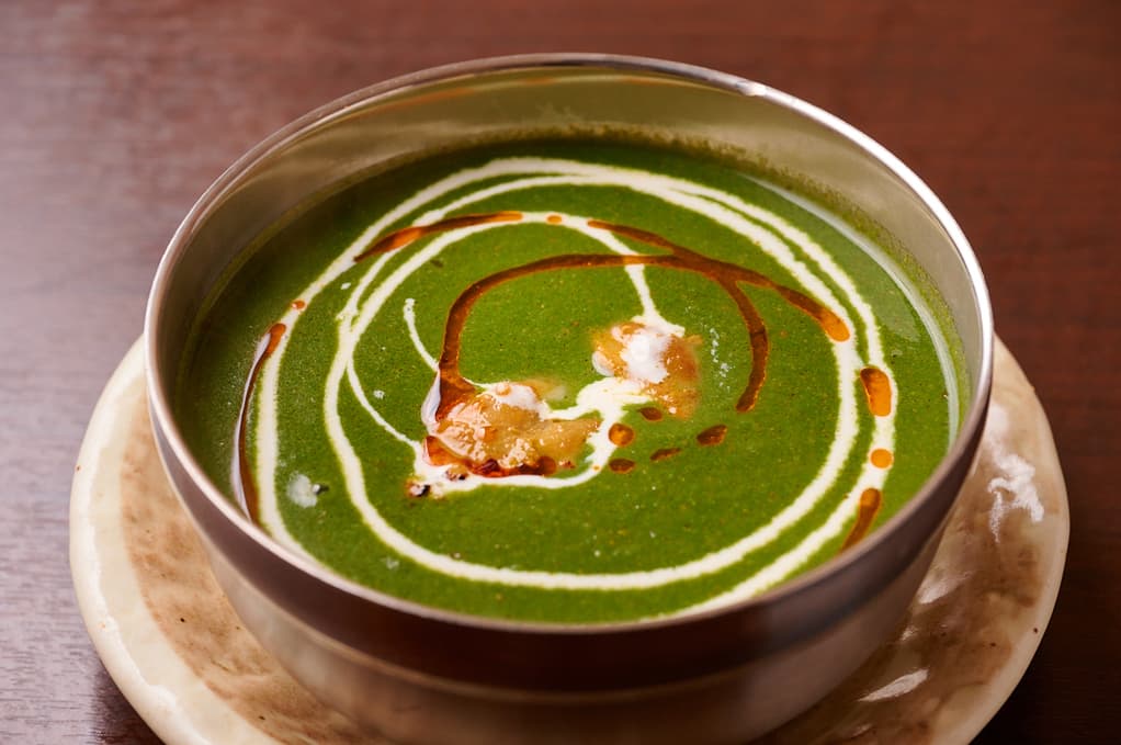 Spinach curry finished with a cream swirl at Sakura Asian Dining & Bar
