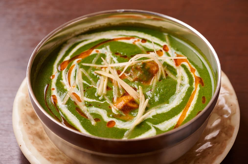 Spinach curry topped with shredded ginger and cream at Sakura Asian Dining & Bar